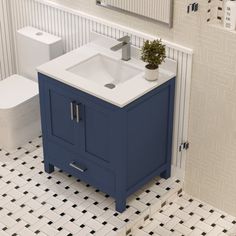 a bathroom with a sink, toilet and mirror on the wall next to tiled floor