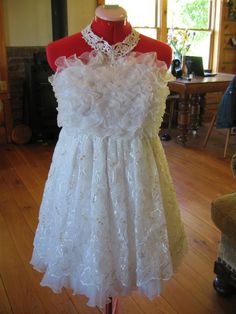 a white dress on display in a room