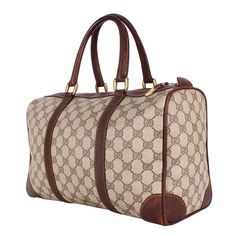 Authentic Gucci brown GG Boston Shoulder Bag Tote. This is a stylish and easy-to-carry tote for the modern woman. Features brown GG PVC, this striking, easy-to-carry tote features dual-rolled handles and gold-tone hardware accents, zipper top closure, and large roomy textile interior lining. This is the perfect everyday bag, gym bag, or traveling bag. Add your wallet, keys, phone, cosmetic case, and much more. Made in Italy Strap Drop: 22" Non-Gucci heavy guage crossbody strap Pre-owned Brown Monogram Canvas Bag, Pre-owned Brown Bag With Double Handle, Pre-owned Classic Gucci Bags, Luxury Pre-owned Brown Bag, Gucci Brown Signature Coated Canvas Bag, Pre-owned Gucci Leather Bag, Pre-owned Rectangular Brown Bag, Beige Gucci Bags In Coated Canvas, Gucci Beige Signature Coated Canvas Bag