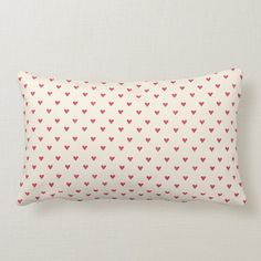 a white pillow with red hearts on it