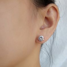 Bring a little bit of style to your look with these chic CZ Solitaire Stud Earrings. These uniquely designed earrings present a fantastic way to highlight your best features while making you look exceptionally stylish. These earrings are high diversified pieces of jewelry that can be teamed with diverse types of dresses. They undeniably give a touch of sophistication to your appearance while adding an element of status. Features: Comfortable to wear Lightweight High quality Tarnish resistant But Dazzling Diamond White Cubic Zirconia Cluster Earrings, Glamorous Round Diamond Earrings For Anniversary, Glamorous Round Earrings With Prong Setting, Dazzling Diamond White Crystal Earrings With Brilliant Cut, Glamorous Round Bridal Earrings With Diamond Accents, Glamorous Bridal Earrings With Diamond Accents, Dazzling Cubic Zirconia Crystal Earrings With Halo Design, Classic Cluster Earrings With Sparkling Cubic Zirconia, Formal Cubic Zirconia Crystal Earrings With Halo Design