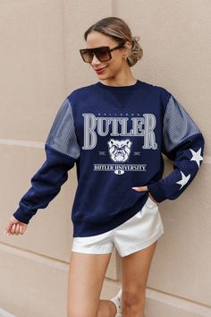 Turning heads won't be an issue with our long sleeve crewneck fleece with ribbed cuffs and waistband. Featuring contrasting jersey mesh upper arm inserts, rhinestud stars on the sleeves, and a 60% cotton and 40% polyester construction, this fashionably unique piece will have you standing out in the crowd. Butler Bulldogs, Upper Arms, Fan Gear, Unique Pieces, Bulldog, Turning, Fitness Models, Slip On, Mesh