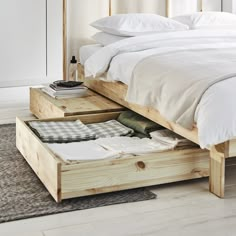 a bed with two drawers underneath it