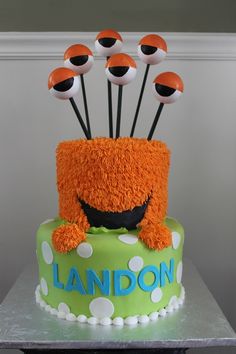 a green cake with orange and black decorations