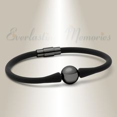 "Our Black Stainless Steel Simplicity Bracelet Cremation Jewelry combines a sleek design with your memories.  A comfortable design is blended with a remembrance you choose and the care and attention of our customer service. ABOUT THIS BRACELET The Black Stainless Steel Simplicity Bracelet Cremation Jewelry is a great gift idea for anyone in your life.  The simple design is will fit a variety of wrist sizes and the shine of the black plating is a great compliment to the muted black of the band. The Black Stainless Steel Simplicity Bracelet Cremation Jewelry has a black silicon band that is comfortable on the wrist.  The black plated over stainless steel ball at the center features a hidden screw that will protect a pinch of ashes inside and the magnetic closure ensures a secure fit.  The Bl Cremation Bracelet, Heartfelt Condolences, The Only Exception, Memorial Bracelet, Urn Jewelry, Great Falls, Wedding Jewelry Bracelets, Comfortable Design, Cremation Jewelry