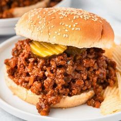 a sloppy joe sandwich on a plate with chips