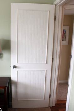 a white door is open in a room