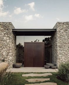 an entrance to a house with stone walls and doors