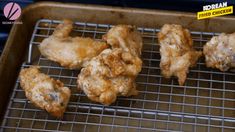 chicken wings are cooking on a wire rack