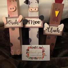 three wooden pegs with farm animals on them and a sign that says i love you