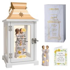 a wedding card box with two figurines in it next to a greeting card