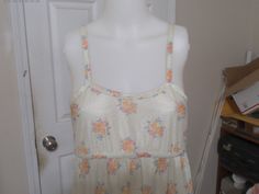 LIGHT YELLOW FLORAL NYLON VINTAGE NIGHTGOWN SIZE:  Small MAKER:  Kayanna 100%  NYLON SIDE LENGTH:  45 inches long FRONT LENGTH over bust:  56 inches long FLORALS OF PINK, BLUE, ORANGE AND YELLOW SHIPPING IS FREE WITHIN THE UNITED STATES NO INTERNATIONAL SHIPPING THANK YOU FOR BROWSING AND HAVE A GREAT DAY! Yellow Summer Nightgown For Sleep, Sleeveless Cream Sleepwear For Spring, Yellow Summer Nightgown, Spring Yellow Nightgown For Loungewear, Vintage Sleeveless Nightgown For Spring, Fitted Yellow Sleepwear For Spring, Vintage Sleeveless Spring Sleepwear, Vintage Sleeveless Sleepwear For Spring, Cream Vintage Sleepwear For Spring