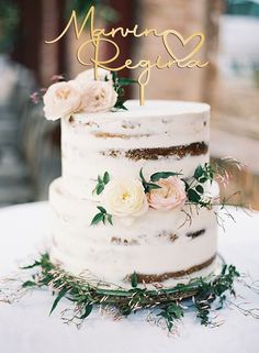 a three tiered cake with flowers on top