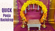 an altar with flowers and candles in front of it, that says quick poja back drop