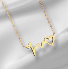 10K 14K 18K Gold Heart Rhythm Necklace, Gold Heart Necklace, ECG Sound Wave Necklace. Handmade Heart Necklace, Christmas Gift, Mother's Day Gift. All jewelry in our collection are real solid gold and completely handmade accessories. The jewelry in our collection, which is an accessory with a bright and eye-catching beauty that will make others notice you and your loved ones in the environments you enter, is a great gift option to add value to the people you care about on special occasions. * Han Gold Plated Jewelry For Valentine's Day Anniversary, Valentine's Day Anniversary Gift Gold Plated Jewelry, Gold Plated Necklace For Anniversary On Valentine's Day, 14k Gold Clavicle Chain Necklace For Valentine's Day, Yellow Gold Heart Clavicle Chain Jewelry, Gold Plated Necklaces For Valentine's Day, Valentine's Day Gold Plated Necklace, Heart Pendant Jewelry For Gifts, Heart-shaped Gold Plated Necklace For Mother's Day