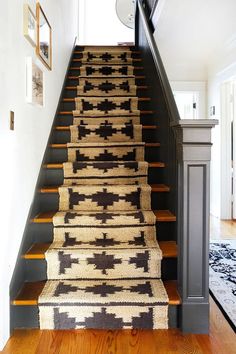 a staircase with carpeted steps leading up to the second floor