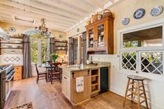 a large kitchen with wooden floors and cabinets