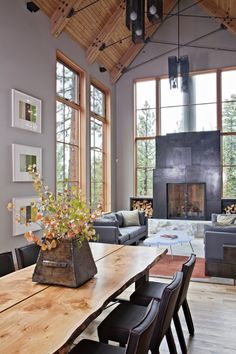 a living room filled with furniture and a fire place in the middle of a room