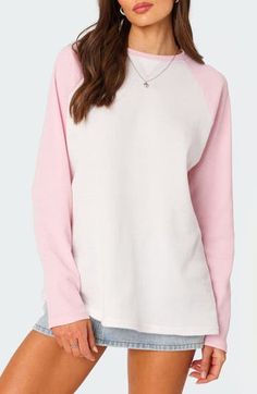 This cozy waffle-knit top is crafted in an oversized fit and framed by sporty raglan sleeves. Crewneck Long sleeves 50% cotton, 50% polyester Machine wash, dry flat Imported Casual Pink Raglan Sleeve Top, Casual Pink Top With Raglan Sleeves, Cozy Pink Crew Neck Top, Cozy Pink Tops With Ribbed Cuffs, Cozy Pink Top With Ribbed Cuffs, Pink Color Block Cotton Sweater, Pink Crew Neck Athleisure Sweater, Spring Sporty Sweatshirt With Raglan Sleeves, Pink Relaxed Fit Tops With Ribbed Cuffs