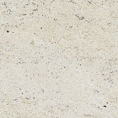 a close up view of the surface of a white marble counter top with small speckles