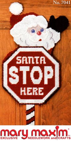 there is a cross stitch santa stop sign on the door