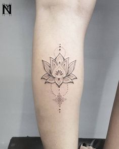 a woman's leg with a lotus tattoo on it