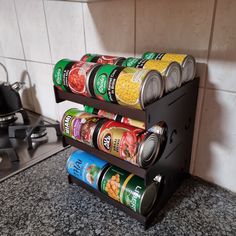 two tiered spice rack holds cans of canned food