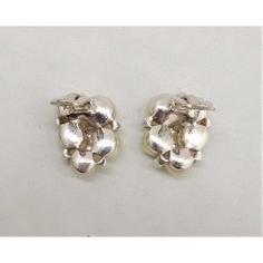 This is part of Chairish’s Costume Jewelry assortment.  Vintage circa 1950s rhodium plated faux-pearl with small round clear rhinestone accents clip back earrings. Marked "Jomaz" Measure: 1 inch long by 3/4 inches wide. Condition: Very good; slight discoloration and mild wear to faux-pearls. Silver Pearl Drop Clip-on Earrings For Evening, Vintage Silver Pearl Earrings For Formal Occasions, Nickel-free Retro Formal Earrings, Nickel-free Retro Earrings For Formal Occasions, Nickel Free Retro Formal Earrings, Nickel Free Retro Earrings For Formal Occasions, Metal Pearl Earrings For Anniversary, Silver Clip-on Pearl Earrings For Evening, Elegant Silver Screw Back Earrings