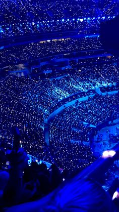 an arena filled with lots of people sitting in it