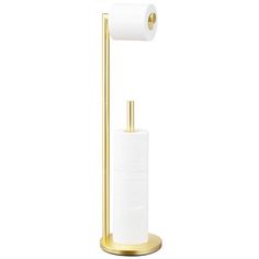 the toilet paper holder is gold and has two rolls of toilet paper on top of it