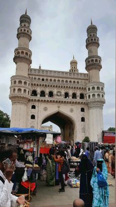 people are standing in front of an ornate white building