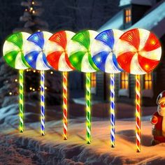 lighted lollipops are lined up in the snow