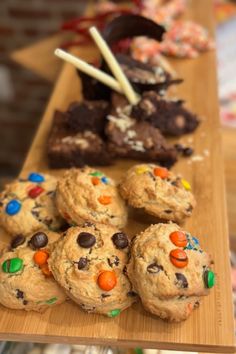 chocolate chip cookies and candy bars on a wooden tray