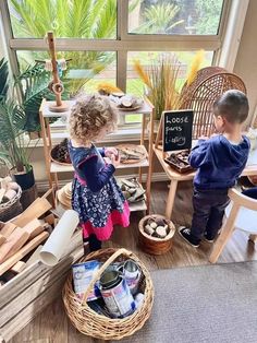 two children are playing with toys in a room filled with plants and other things on the floor