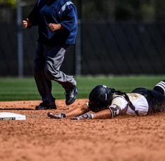 a baseball player sliding into home plate during a game