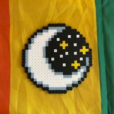 a black and white object with yellow stars on it's side, in front of a flag