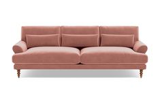 a pink couch sitting on top of a white floor