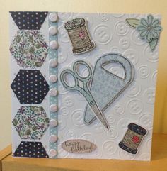 a close up of a card with scissors and other items on top of the card