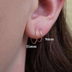 • Two sets of Tiny Hoop Earrings • (4 earrings in total) • 14K gold-filled or sterling silver. When you select a quantity of '1' you will receive two pairs of hoops. - The model is wearing 9mm and 11mm hoops. - You'll receive one set of 9mm hoops and one set of 11mm hoops unless you choose custom sizes. - If you want custom sizes, write them in "notes to seller" upon purchase. - Sizes 8mm - 11mm available. Purchase Hoops Individually: https://www.etsy.com/listing/791336853/gold-mini-hoops-14k-go Luxury Gold Huggie Earrings With Ear Wire, Tiny Gold Hoop Earrings, Little Hoop Earrings, Simple Silver Earrings, 4 Earrings, Xmas 2024, Tiny Hoop Earrings, Cartilage Hoop, Small Hoop Earrings