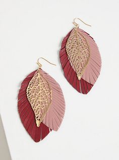 two pairs of pink and gold leaf shaped earrings on top of a white surface,