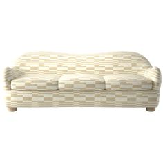 a white and beige checkered couch sitting on top of a wooden table