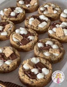 chocolate chip cookies with marshmallows and chocolate chips on top in a baking pan