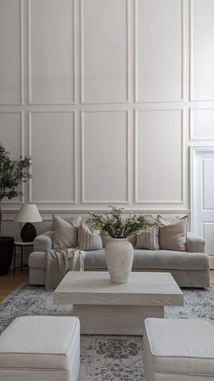 a living room with white walls and furniture