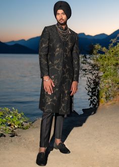 Presenting the iris achkan from our new collection monet, with hints of gold over a black ensemble, perfect all your upcoming night functions! Paired with tapered trousers. Elegant Sherwani For Festive Evening, Elegant Black Sherwani For Formal Occasions, Elegant Evening Sherwani For Festive Occasions, Elegant Black Suits With Zari Work, Black Suits With Zari Work For Formal Occasions, Luxury Black Sherwani With Straight Kurta, Luxury Black Kurta For Festive Occasions, Gold Festive Evening Suit, Festive Gold Sherwani For Semi-formal Occasions