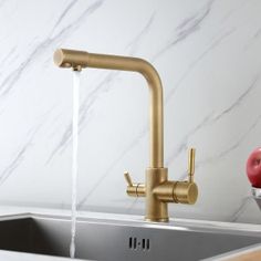 a kitchen sink with a faucet running water from it's spout