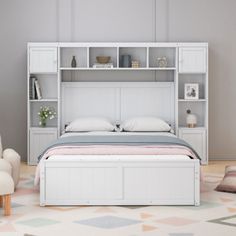 a bedroom with a bed, chair and bookcases on the wall above it