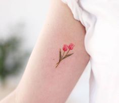 a woman's arm with pink flowers on it