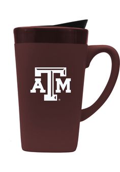 the texas a & m travel mug is shown in maroon with white letters on it