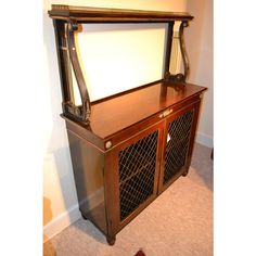 an old wooden cabinet with a harp on it's front and side doors open