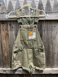 From top of overalls to bottom of shorts: 21in  From belt to bottom of shorts: 10in Waist (measurement when laying flat): 15in Bee Overalls, Overalls Design, Gardner Outfit, Sunflower Overalls, Overalls Gardening, Fun Overalls, Daisy Clothes, Daisy Outfit, Floral Overalls